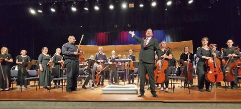 Music Director David Mills proudly presents the Mount Pleasant Community Orchestra for applause after the performance TRIBUNE PHOTO / NICOLE KIMBALL