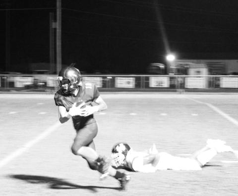 Rivercrest’s Connor Herring breaks away from a Harleton defender on his way to a 36-yard touchdown. The Rebels fell short against the Wildcats, 44-26. TRIBUNE PHOTO / QUINTEN BOYD