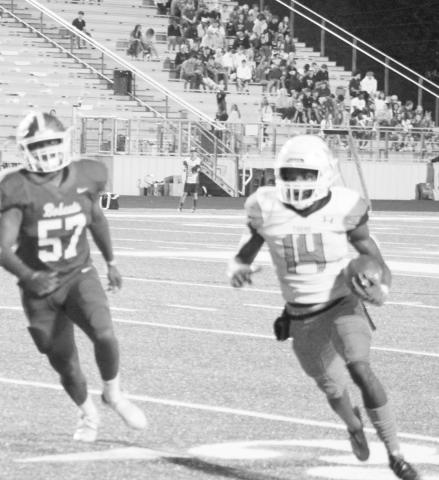 MP’s Ed Wilder heads for open field as Hallsville’s Gavin Mendez tries to pursue him. Wilder finished with 181 yards rushing and a touchdown, but the Tigers fell to the Bobcats, 26-20. TRIBUNE PHOTO / QUINTEN BOYD