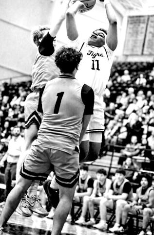 Zeke Hill attacks the paint defended by two Whitehouse Wildcats in the Tigers’ win on Friday. Hill had 11 points.