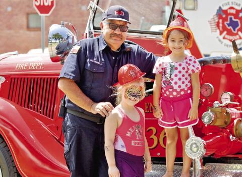 The Mt. Pleasant fire dept. posed with kids at the Mt. Pleasant Farmers Market on July 12 Photo courtesy of City of Mt. Pleasant