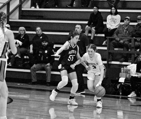 Chapel Hill’s Ellie Wooten drives against Martins Mill’s Kara Nixon during Tuesday’s game. The Lady Devils fell against the Lady Mustangs, 56-30, and will play at home Monday and Tuesday afternoon against New Boston and Douglass.