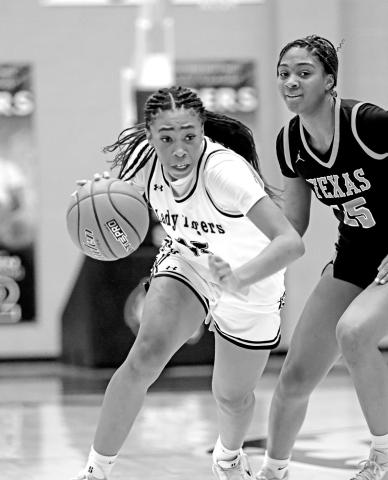Shannon Hines attacks the paint against the Texas High Lady Tigers. Hines led Mt. Pleasant with 14 points.