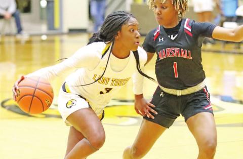 Paris Beard drives to the basket against a Marshall defender. COURTESY PHOTO / JOHN WHITTEN