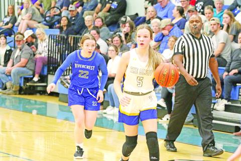 Rivercrest’s Anna Duvall chases Harts Bluff’s Kaylee Clay during Tuesday’s game. The Lady Rebels defeated the Lady Bulldogs, 56-22.