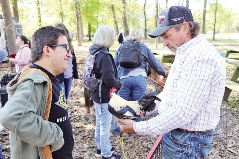 A volunteer tells Jazziel Resendiz about some of the animals that live on the ranch