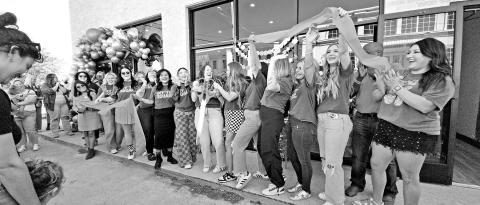 Staff, family, and friends cheer as the ribbon is cut for ‘Off the Square’ TRIBUNE PHOTO / NICOLE KIMBALL
