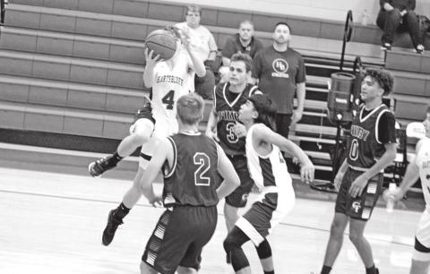 Ashyr Carrington splits the Cumby defense for a layup in Tuesday afternoon’s game. Harts Bluff’s JV 1 team defeated the Trojan varsity, 57-49. TRIBUNE PHOTO / QUINTEN BOYD