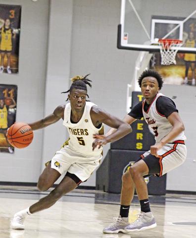 Mount Pleasant’s Reggie Webster (5) gets past a Texas High defender during Friday night’s home game.