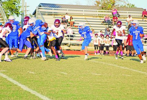 Pewitt eighth grade running back Zahkevion “Wooda” Betts fights for yardage during the junior high Brahmas’ game against New Boston Thursday. Betts, Kade Nix and Terry Versailles scored rushing touchdowns; Nix threw a touchdown pass to Kayden Young and Cruz Zavala had a number of tackles on defense, but the eighth grade lost a heartbreaker, 32-28.