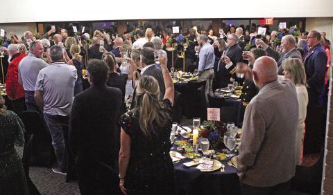 Guests raise a toast recognizing those who have served the country.