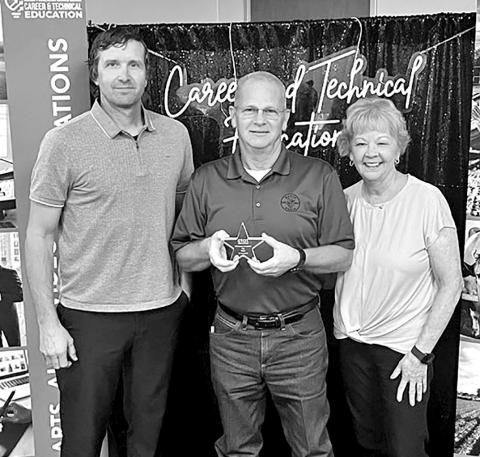 Tim Davis (center) receives his award at a Regional meeting for Regions 7 and 8 in Kilgore with Career and Technology Director, Jay Silman (left) and his wife, Donna Davis, who teaches business classes at Mount Pleasant High School COURTESY PHOTO