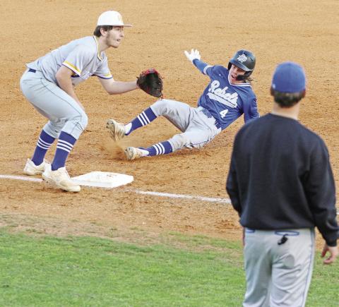 Rivercrest’s Cason Fields slides into third base as Harts Bluff’s Hunter Green awaits the throw. The Rebels defeated the Bulldogs, 12-1, Tuesday at NTCC’s Eagle Field at Bob Baker Stadium.