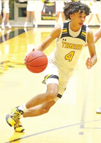 Kai Price drives to the basket. PHOTO BY JOHN WHITTEN