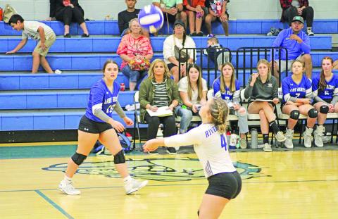 Rivercrest’s Logan Huddleston prepares for a bump as teammate Stoney Carey looks on during a recent match. Rivercrest traveled to Clarksville Tuesday and will open the second round of district play Friday at home against Harts Bluff. TRIBUNE PHOTO / QUINTEN BOYD