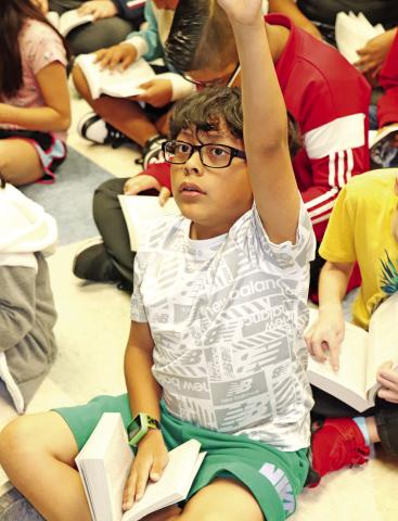 Sims 3rd grader Hatzael Antolin finds an answer in his new dictionary