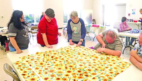 Volunteers work together for National Make a Blanket Day
