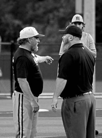 Mount Pleasant Tiger head baseball coach Tommy Stewart has a discussion with an umpire about a balk call during a district playoff game against Texas High last week. Coach Stewart probably has a few more gray hairs after back-to-back, one-run games ended his Tigers’ season this past weekend.