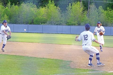 Rivercrest’s Ethan Taylor flips a ball to Mark Grider while Chase Duffer backs up the play during a recent game. Going into their final regular season game Tuesday, the Rebels were tied for third in district with Ore City and Linden-Kildare. TRIBUNE PHOTO / QUINTEN BOYD