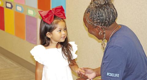 Child Development Center teacher, Tracy Franklin, gets to know a new student.