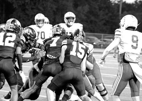 Shane Watkins (7) and Tanner Marshall (15) combine to make a tackle during the Tigers’ game against Sulphur Springs Friday. Watkins recorded four tackles, while Marshall tallied three tackles.