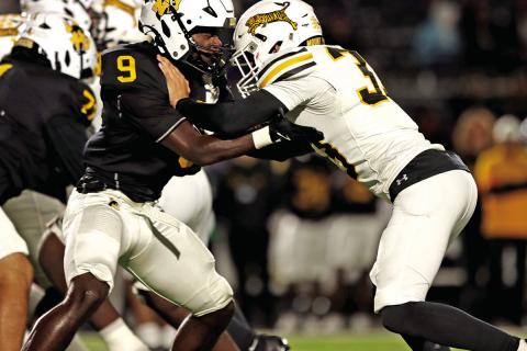 Linebacker Cooper Rider fights through a block just before the half. Rider had 7 tackles for the Tigers.