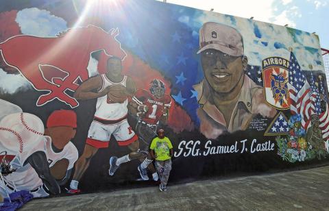Darlene Taylor posed in front of the mural she worked on, week after week, to honor Sam T. Castle ( Photo by Nicole Kimball)