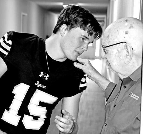 Senior Tanner Marshall discusses football with resident Tilmon Clark.