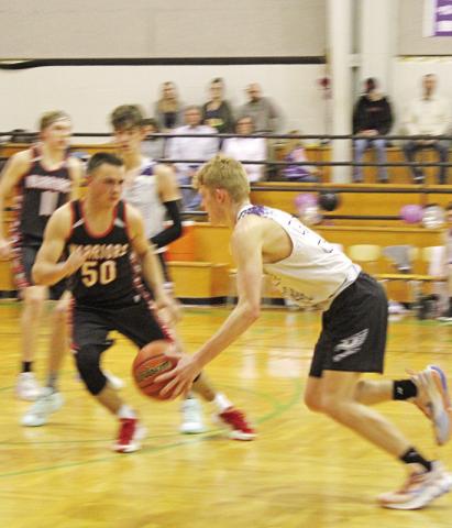 CHAAMP’s John Hall dribbles at the top of the key guarded closely by a Paris defender.
