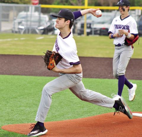 Drew Wigley hurls his final warmup pitch before a game against Dallas HSAA while third baseman Bradon Wafford looks on.