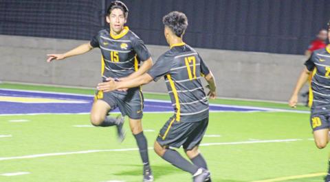 Mount Pleasant’s J.D. Mendoza (left) celebrates with Erick Soto after Mendoza’s goal in Tuesday’s area round game at Sulphur Springs against Midlothian. TRIBUNE PHOTO / QUINTEN BOYD
