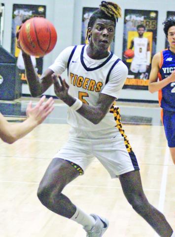 Reggie Webster and the 17th-ranked Mount Pleasant Tigers kicked off district play Tuesday with a win at Hallsville, 56-46. Mount Pleasant is 2-0 in district play, also defeating Whitehouse, 38-20. The Tigers played at home Friday night against Texas High and will take on Pine Tree at home Tuesday. TRIBUNE PHOTO / QUINTEN BOYD