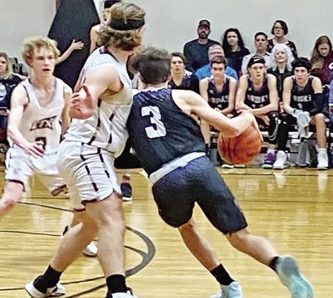 CHAAMP’s Drew Wigley keeps his legs churning to get around an ETHS defender at the top of the key. COURTESY PHOTO
