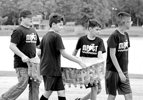 (L to R) Thatcher Drange, Jake Jones, Juan Carrillo, and Joseph Adame carry their creation to the water.