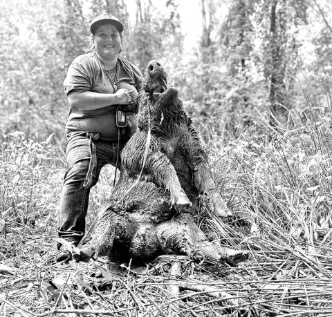 Haelee Modisett with a big boar she and her dogs wrangled in Angelina County. (Courtesy Photo)