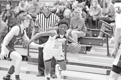 Kelcey Morris looks for room to drive versus Hallsville. PHOTO BY JOHN WHITTEN