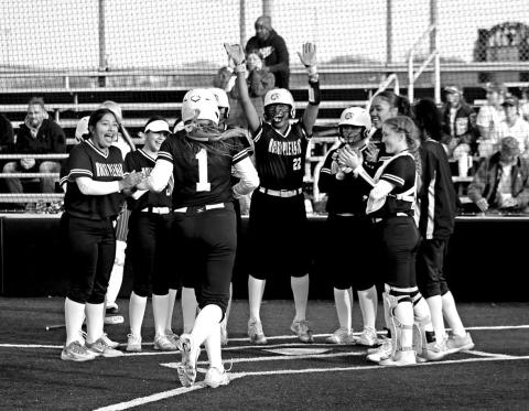 Mount Pleasant’s Kammie Terrell (1) is greeted at home after clobbering a home run against New Boston last week.