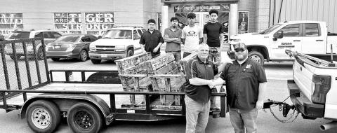 City of Mount Pleasant Public Works Director Garrett Houston (front right) picks up the new benches for Dellwood Park from MPHS Construction teacher Jim Alston (front left) and some of the MPHS Construction students COURTESY PHOTO
