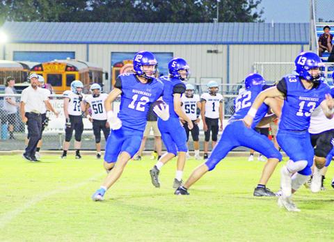 Mark Grider looks for yardage during a recent game. Grider had three catches for 133 yards and a touchdown and picked off a pass for the Rebels, who take on Alba-Golden Friday. TRIBUNE PHOTO / QUINTEN BOYD