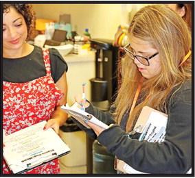 Lexi Agnew takes an order from Eva Beles at the MPISD Administration Building.