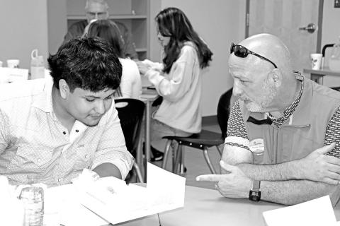 Chick-Fil-A Owner/Operator, Chuck Howard (right), gets to know MPHS senior, David Cumpian, over lunch