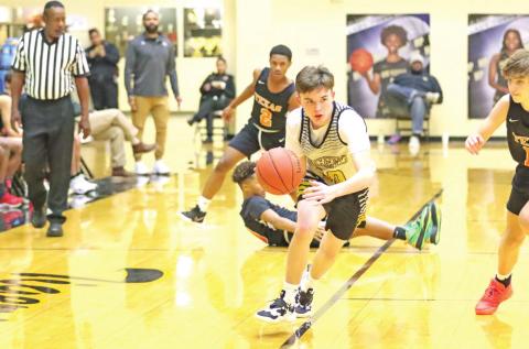 A Tiger drives the ball up the court. COURTESY PHOTO