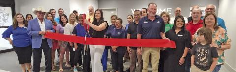 The red ribbon is snipped for the re-opening of Hampton Inn TRIBUNE PHOTOS / NICOLE KIMBALL