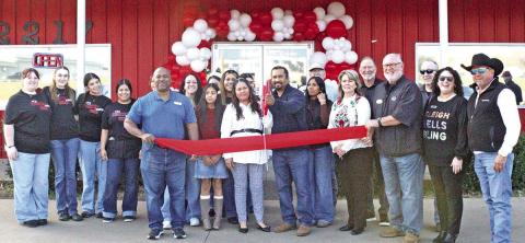 Owner of Country Cafe Diner, Uriel Sanchez, cuts the ribbon at ceremony.