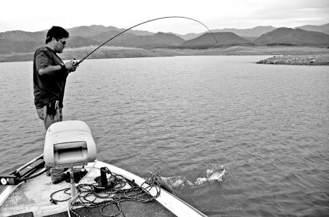 The late Rene Salazar battles a bass that grabbed his crankbait as it dredged a rocky bottom at the confluence of several underwater points and a channel drainage at the upper reaches of the Sinaloa River at Mexico’s Lake Baccarac. (Photo by Matt Williams)