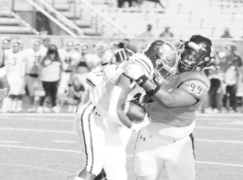 Defensive end Tre Emory takes down a Pine Tree runner last season. COURTESY PHOTO / JOHN WHITTEN
