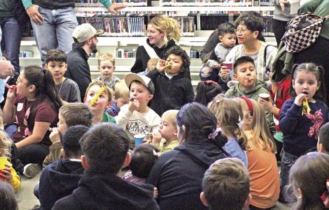 Children played with noisemakers as they eagerly awaited for noon.