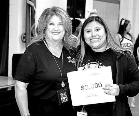 Tonya Murray presents a grant for an interactive Smart Board to Brice teacher, Jessica Soc