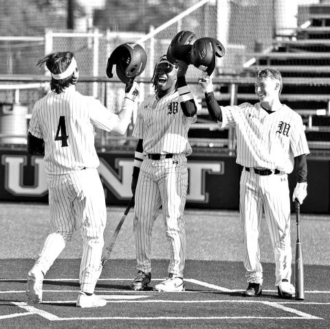 Mount Pleasant’s Drew Cross (4) is greeted at home plate by teammates after belting a home run during a recent home game. COURTESY PHOTOS