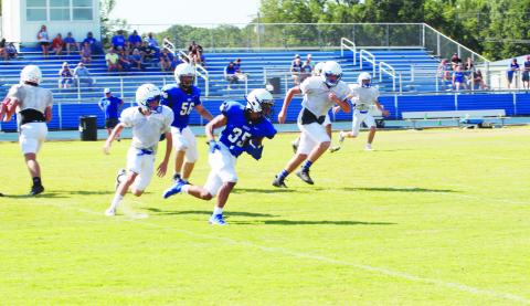 Isaiah Hunter makes a cut on what would become a touchdown run during Rivercrest’s scrimmage against Detroit at The Swamp. The Rebels scored four times in the live quarter. TRIBUNE PHOTOS / QUINTEN BOYD